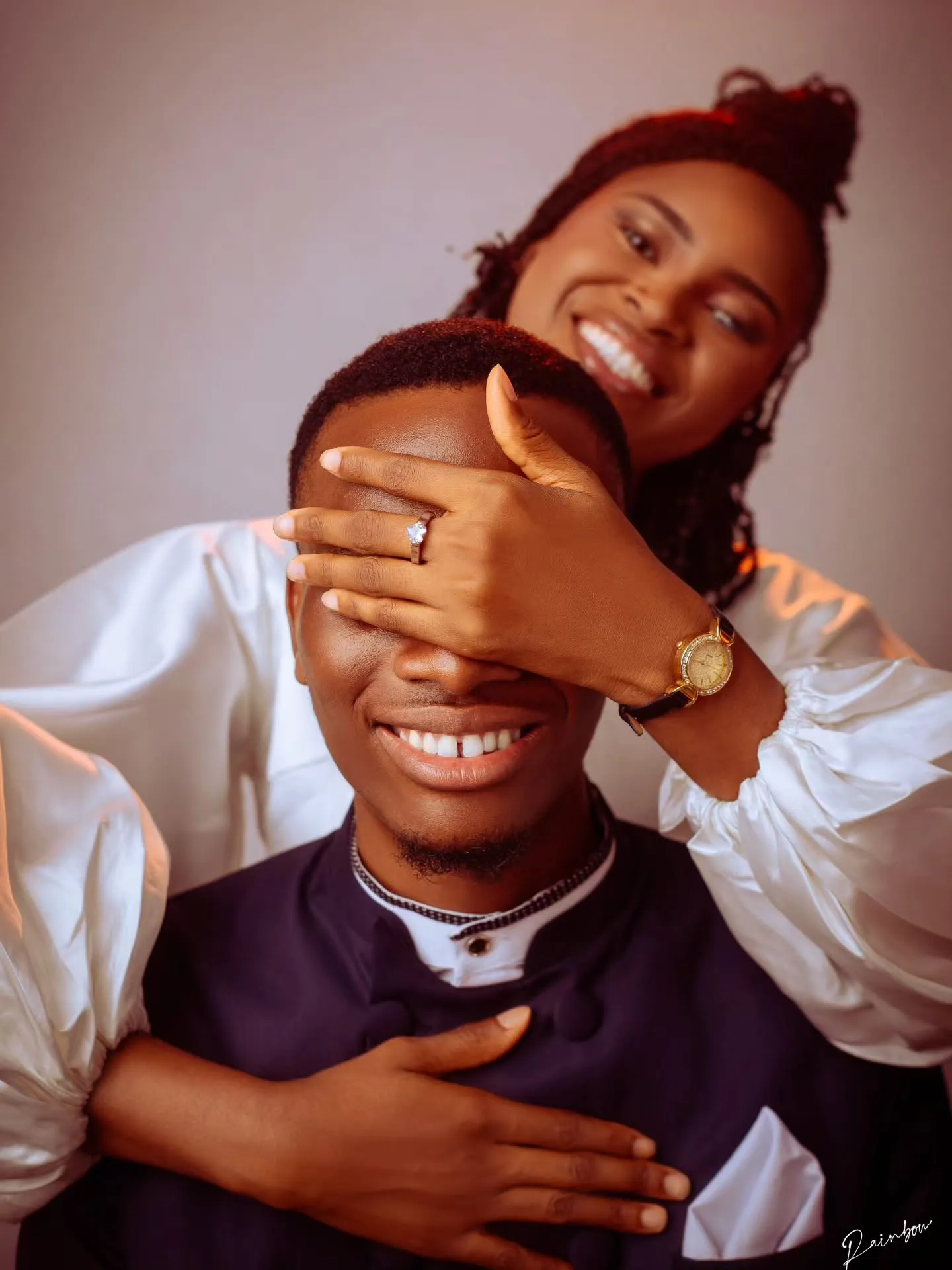 Bride-to-be covering her fiancé’s eyes from behind