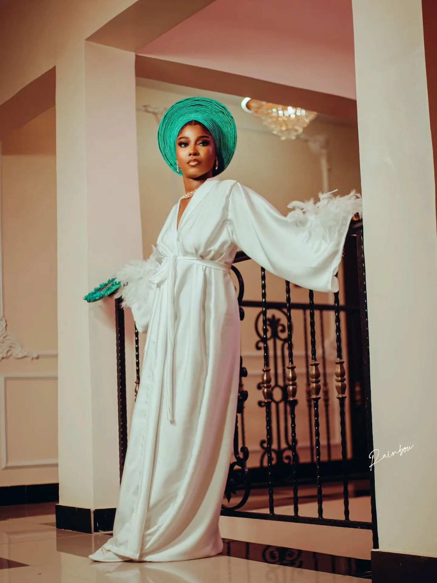 Bride posing in a doorway in a flowing white robe