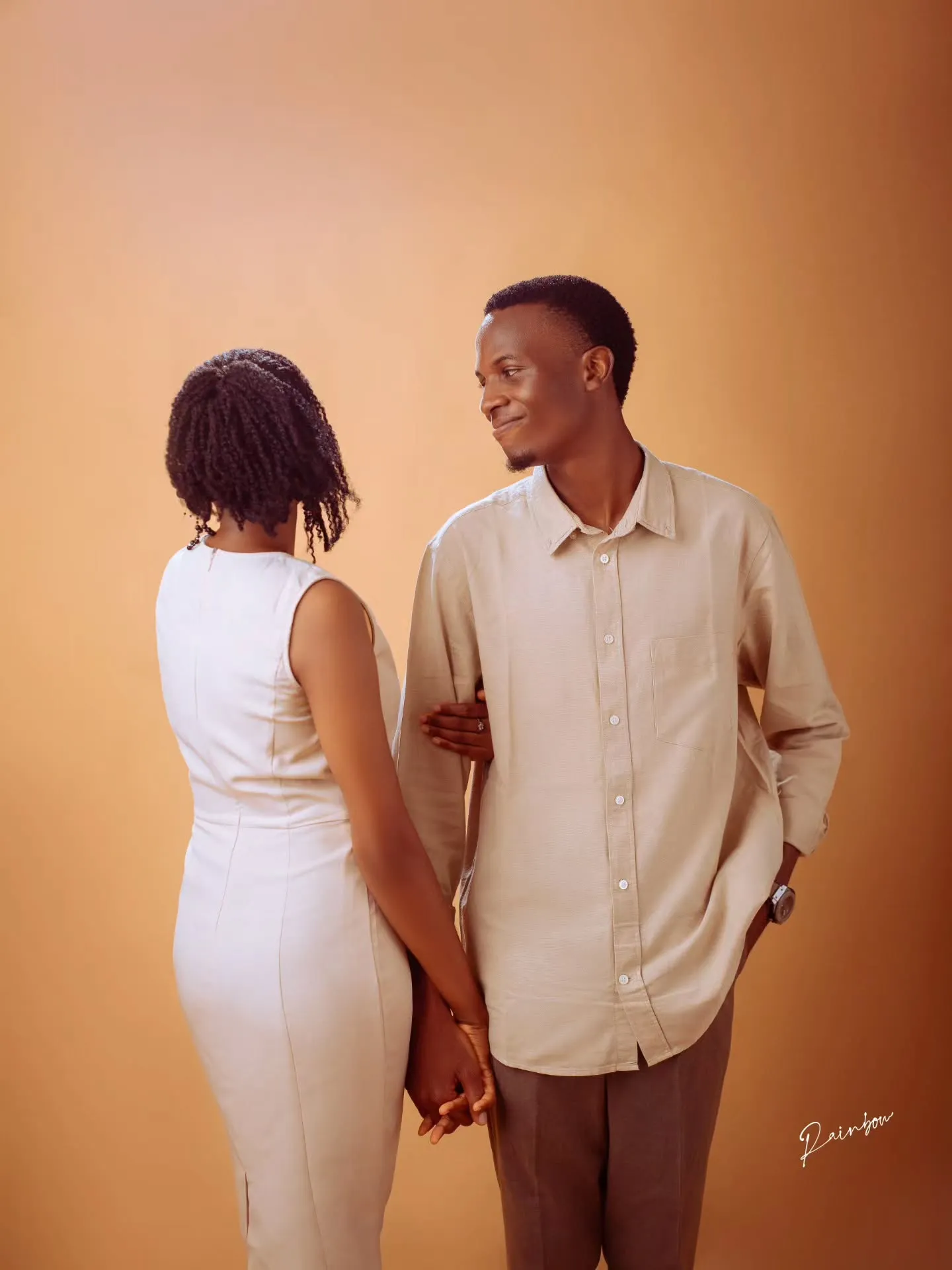 Couple holding hands and smiling at each other