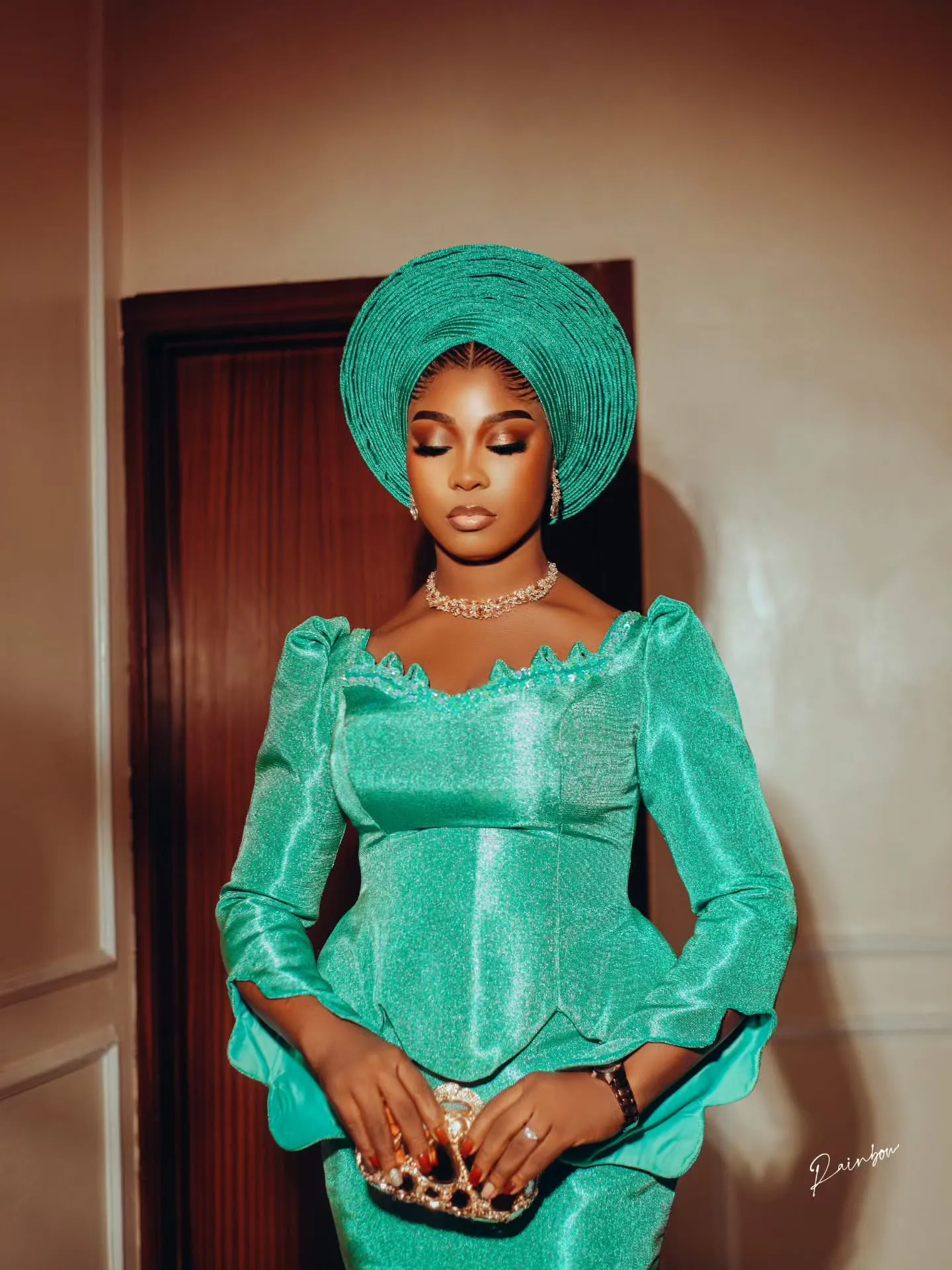 Bride in an emerald corset gown and gele