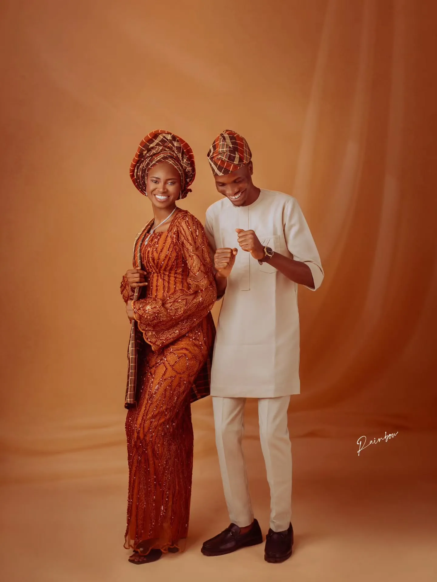 Couple standing together in aso-oke, full length