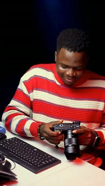 Rainbow holding his camera at the studio